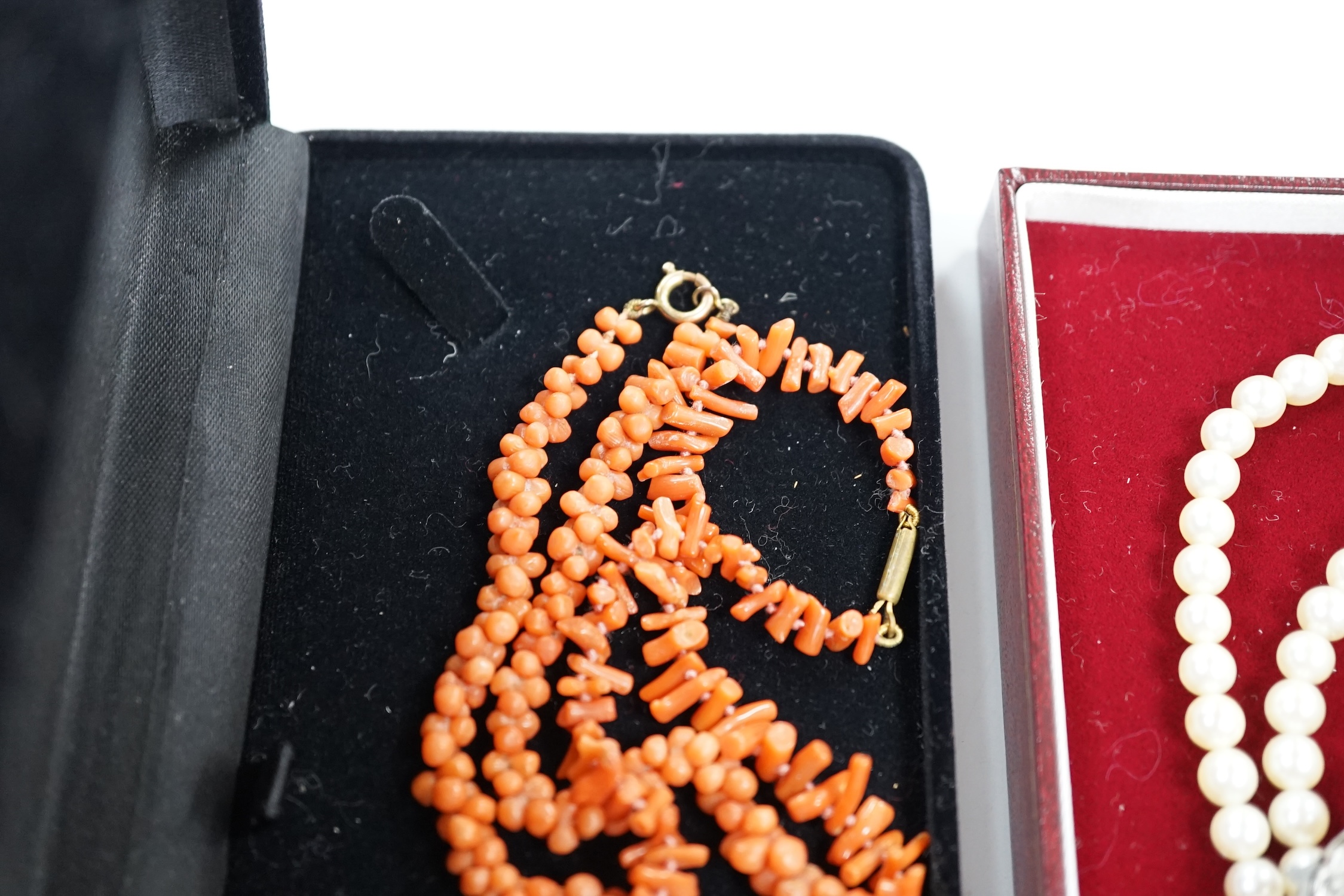 Two coral necklaces, one with beads the other branches, 33cm and a double strand cultured pearl necklace, with marcasite set clasp.